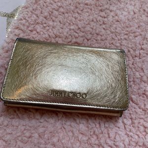 JIMMY CHOO.. Gold wallet. Great addition to any collection. Many compartments
